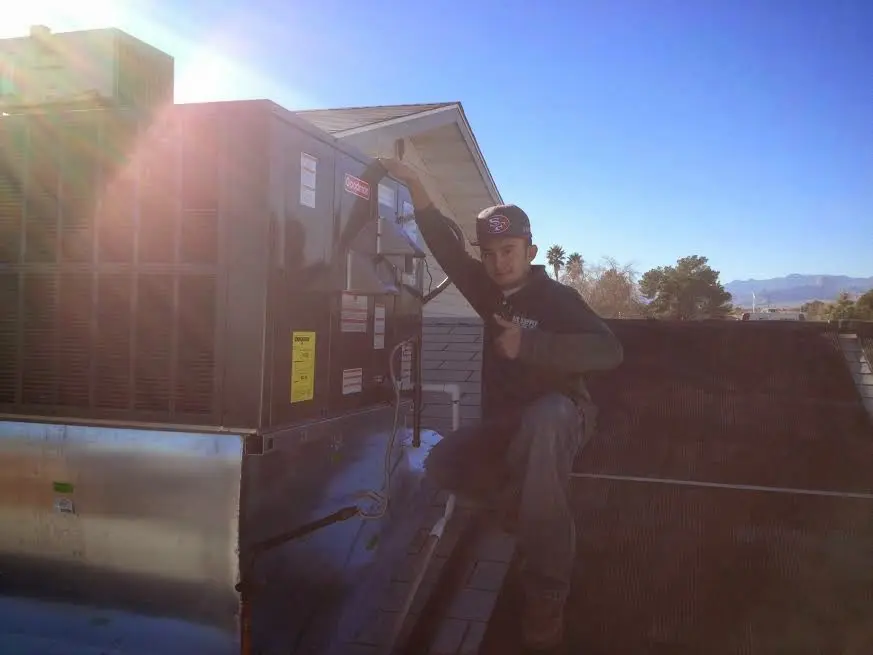 HVAC technician performing HVAC Inspection on a rooftop unit in Moreno Valley